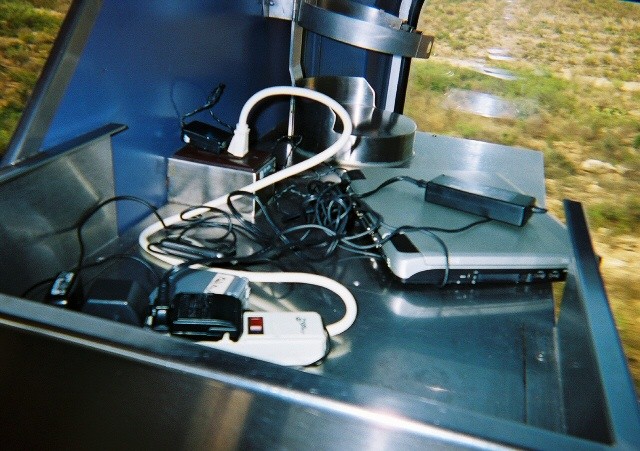 cell phones & computers charging on the train in a little, improvised "nest"